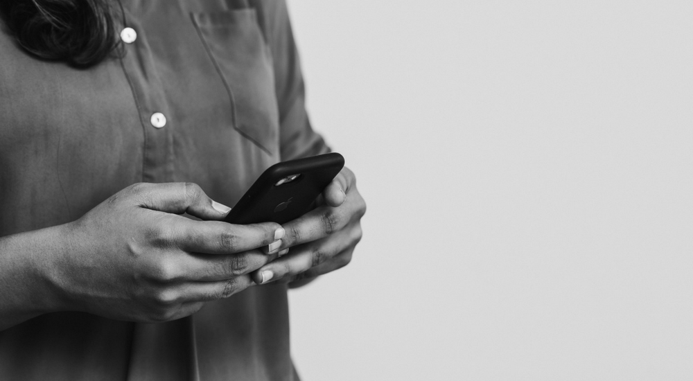 A close up of a woman's hands holding a phone.