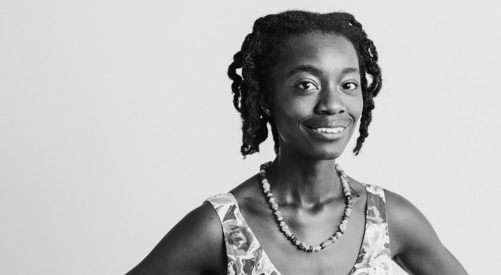 Woman of colour looking at the camera with a slight smile