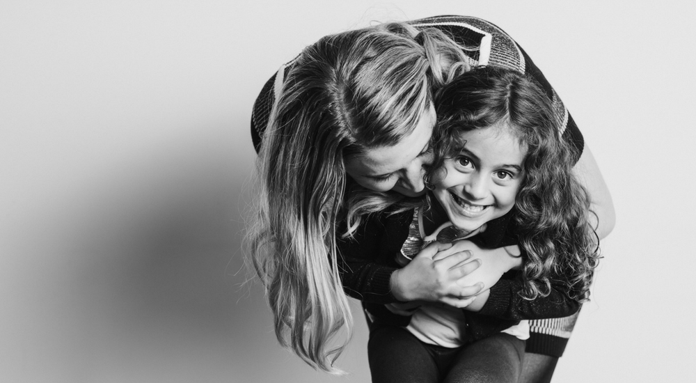 Woman hugging her young daughter