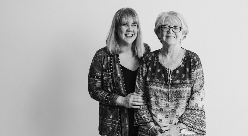 Mother and her adult daughter laughing and smiling