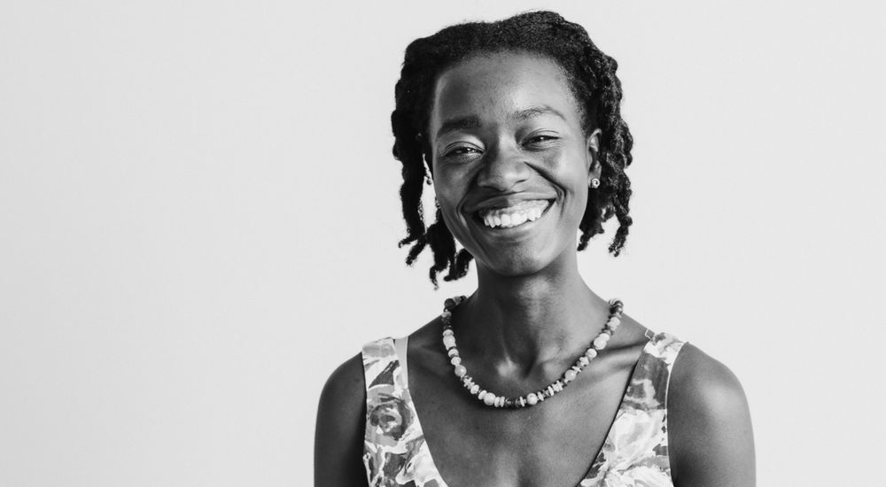 Woman with dreadlocks smiling at the camera